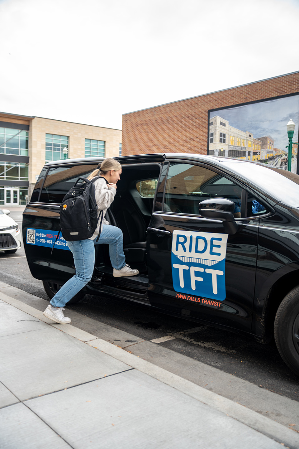 College student getting into Ride TFT van with her schoolbag