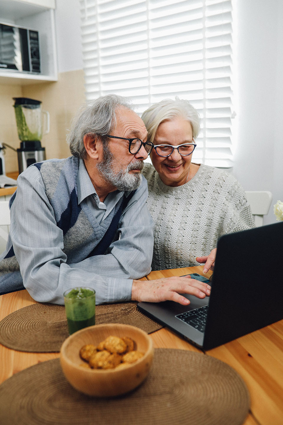Elderly couple looking at their laptop to learn more about Ride TFT